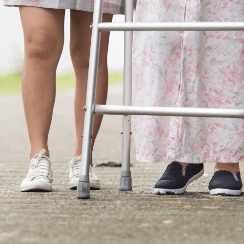 The feet of an older woman and younger woman walking together